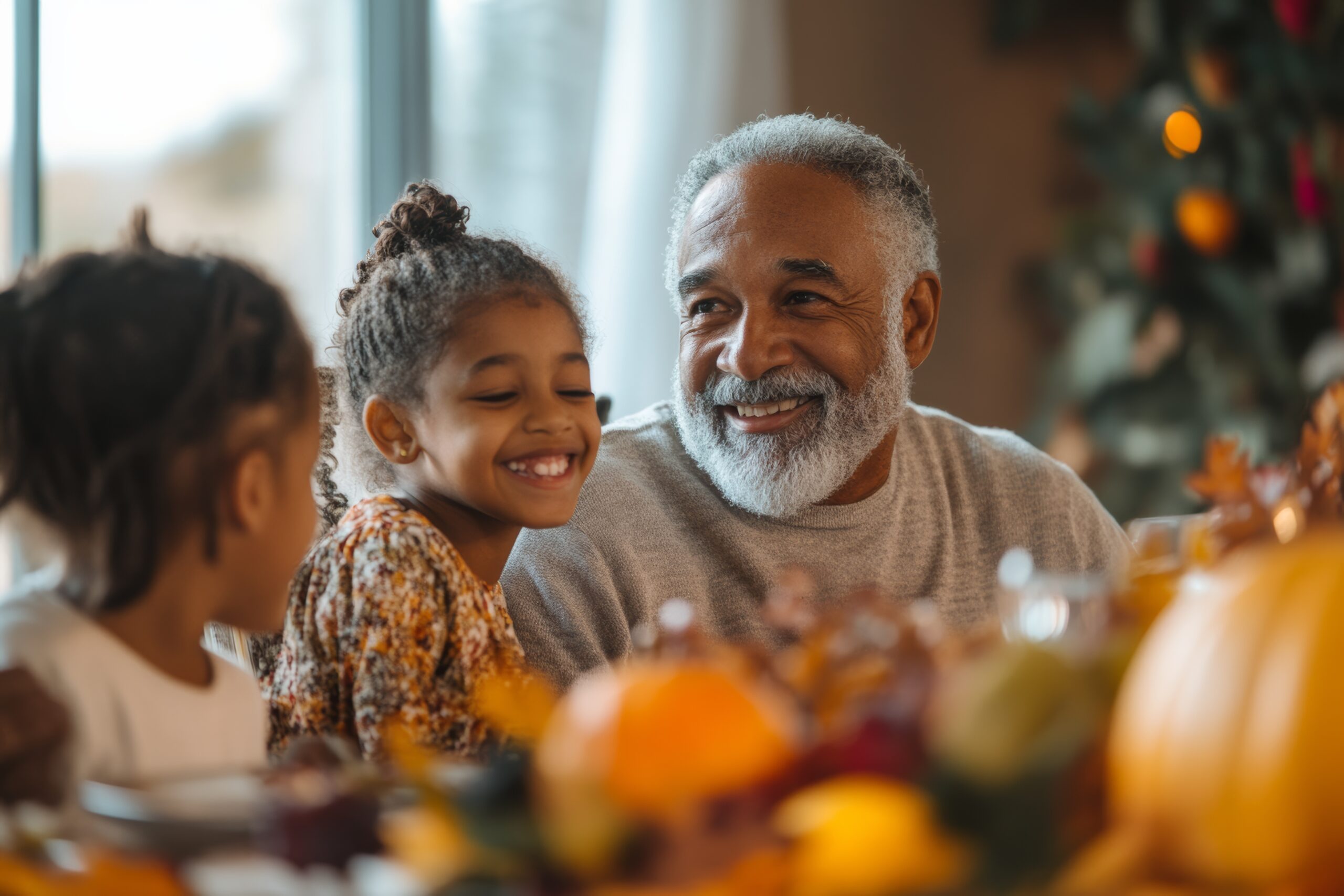 diverse family at Thanksgiving dinner at home. Grandfather with grandkids celebrating with turkey on the table diverse family at Thanksgiving dinner at home. Grandfather with grandkids celebrating with turkey on the table