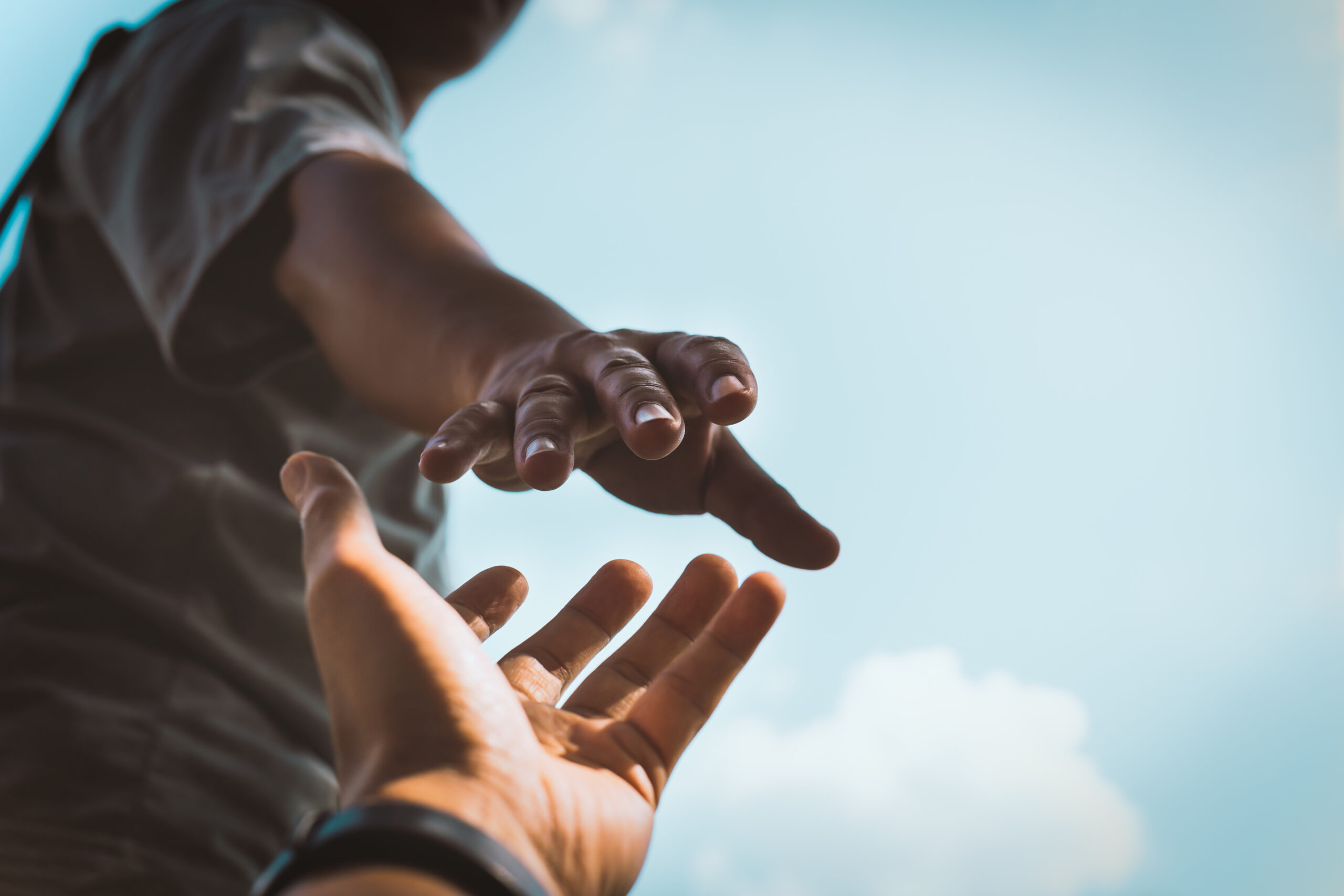 Help Concept hands reaching out to help each other in dark tone. Help Concept hands reaching out to help each other in dark tone